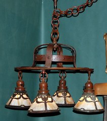 Arts and Crafts hammered copper Handel chandelier with slag glass tulip design shades.